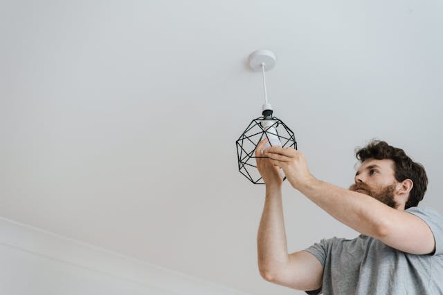 Person installing a light fixture